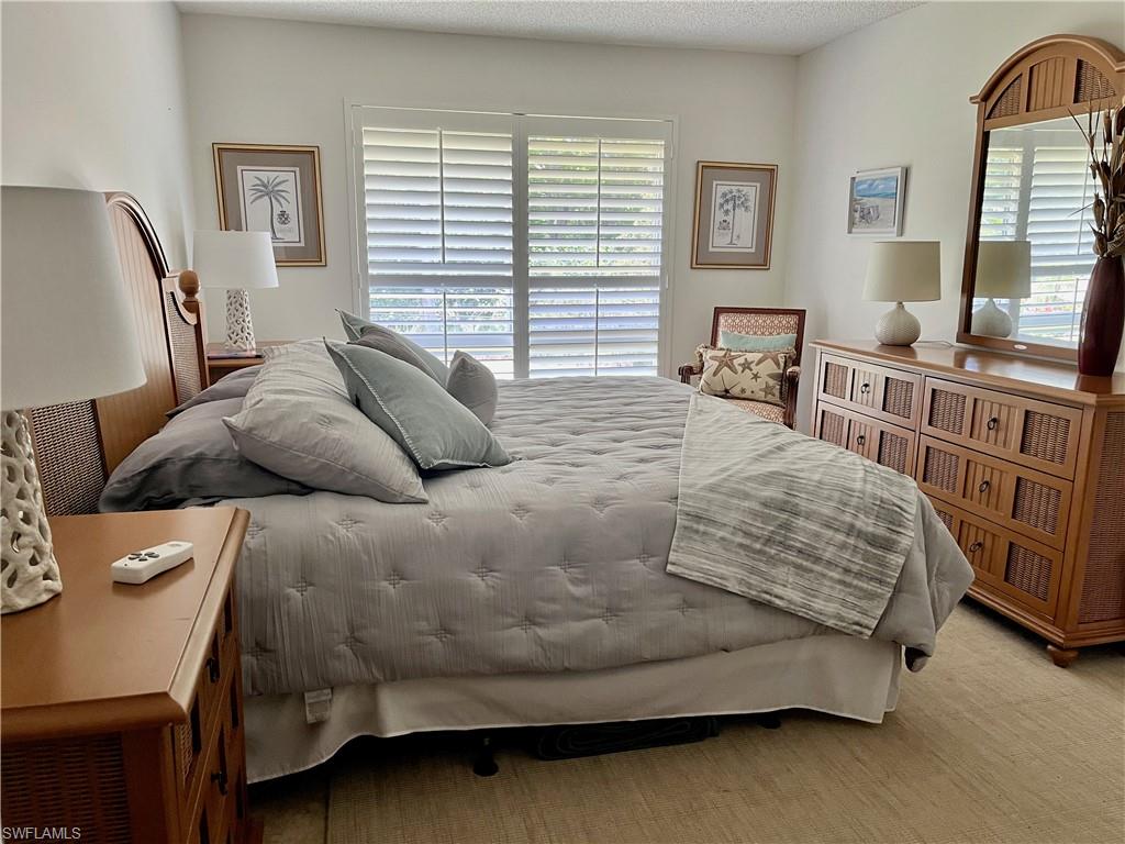 King Bed in Guest Room with large closet and dresser.