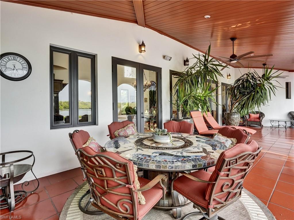 Expansive outdoor living area featuring a terracotta tile floor and a wood-paneled ceiling