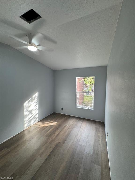 Room featuring wood-finish flooring, a window, and a ceiling fan with integrated lighting