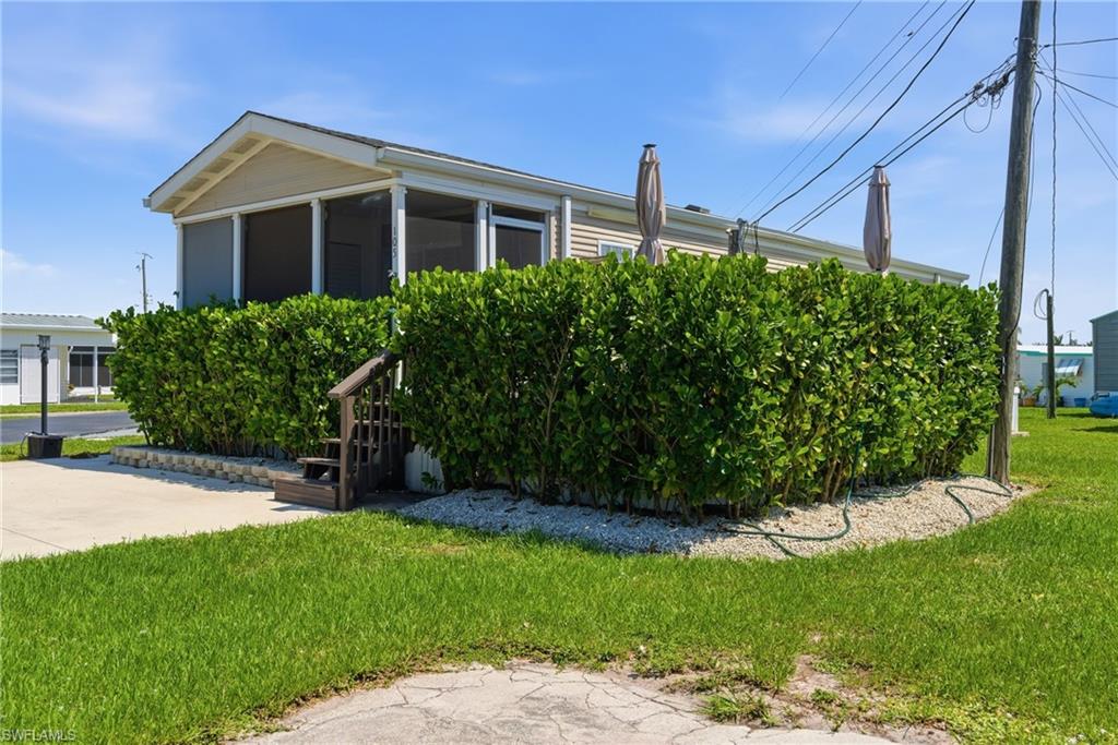 Front of property with paved driveway and landscaping around Deck