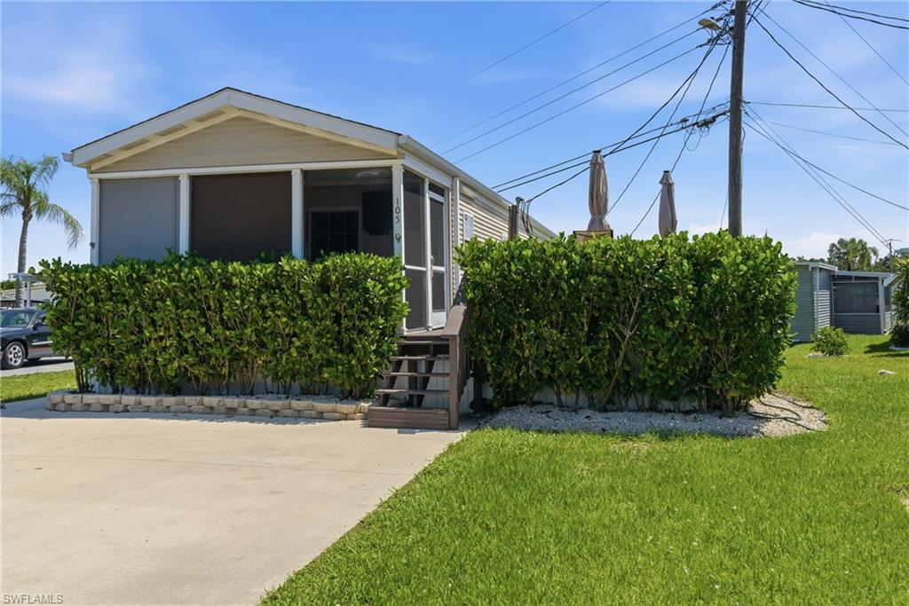 Front of property with paved driveway