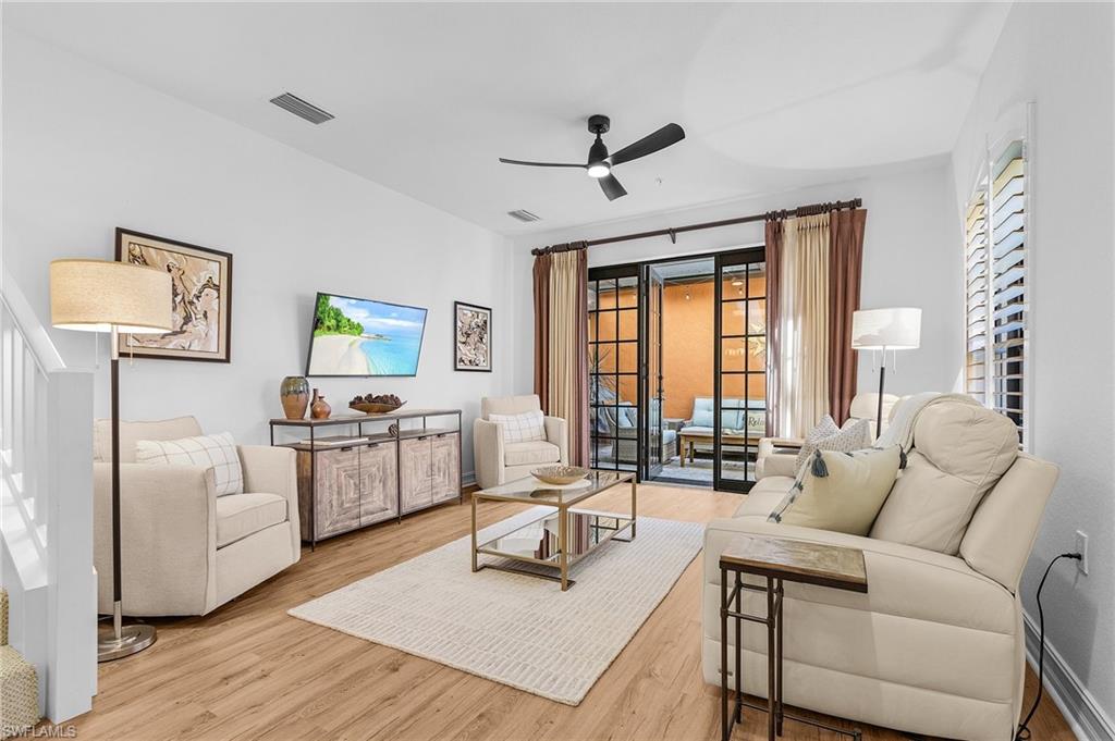 Living area with a ceiling fan and wood finished floors