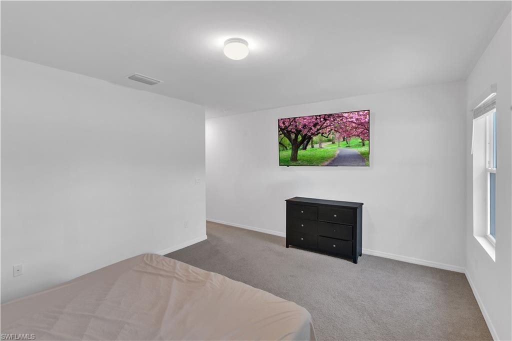 Carpeted bedroom with baseboards