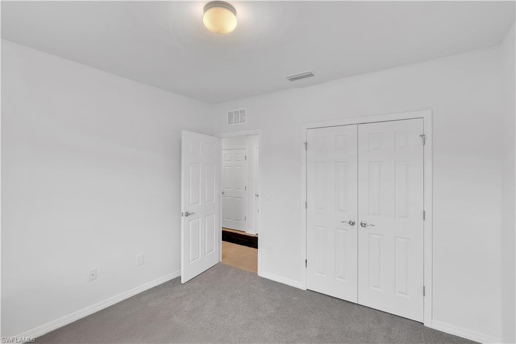 Unfurnished bedroom with carpet floors and a closet
