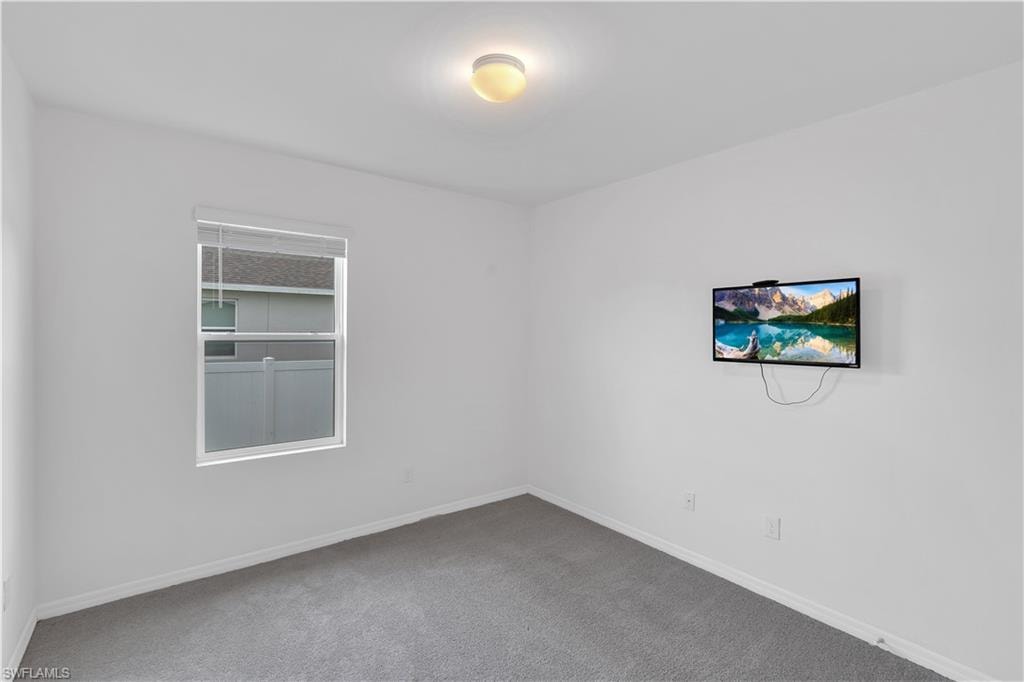 Unfurnished room featuring carpet flooring and baseboards