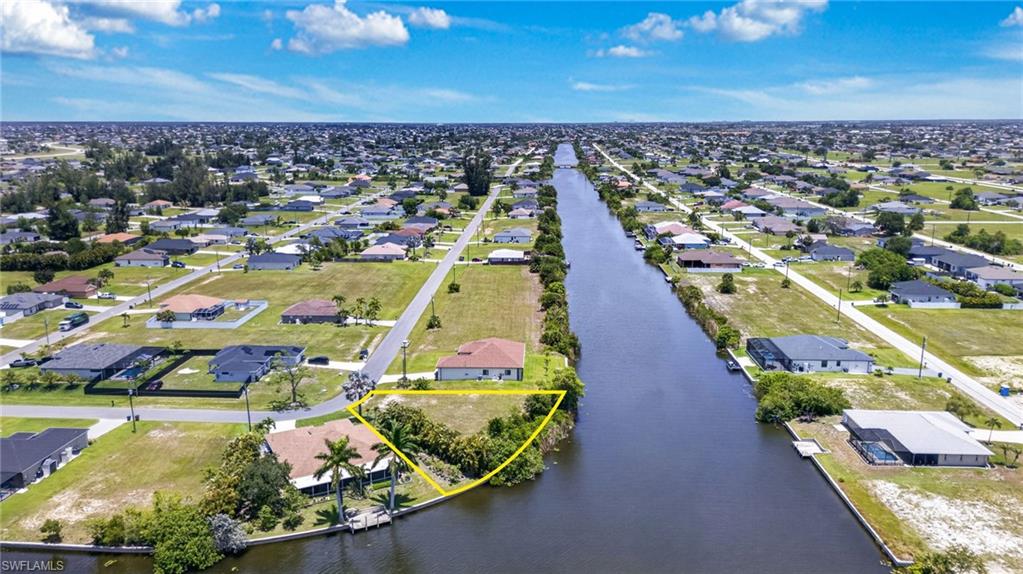 Waterfront parcel featuring direct canal access, expansive lot size, and mature landscaping
