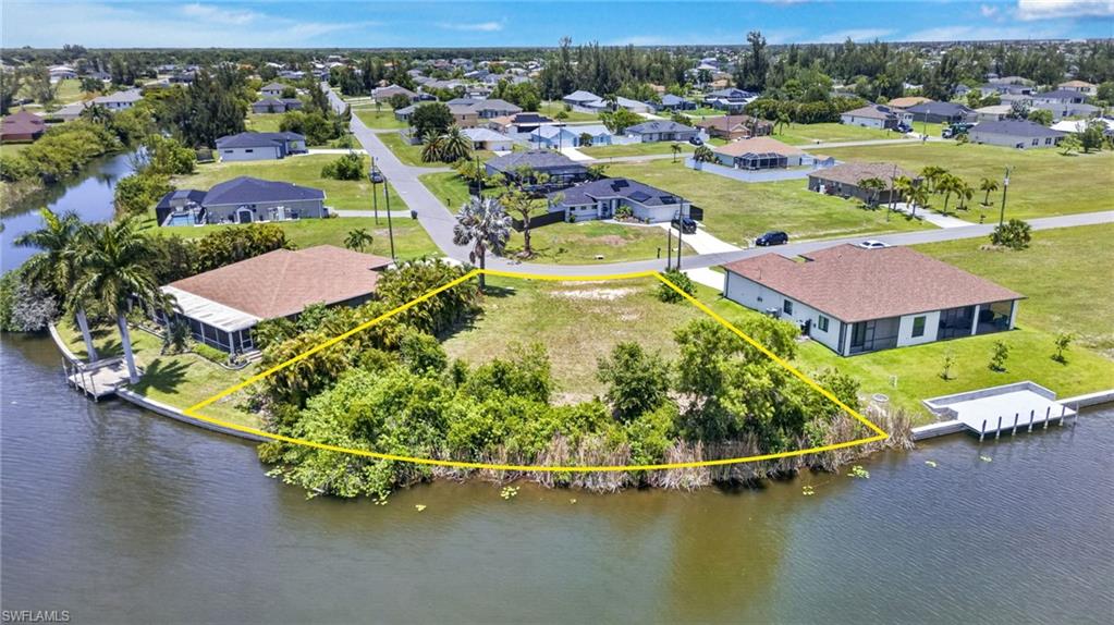 Waterfront lot featuring direct canal access, mature trees, and street frontage