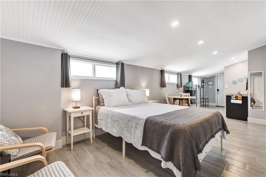 Open-concept room featuring wood-finish flooring, recessed lighting, and a beadboard ceiling