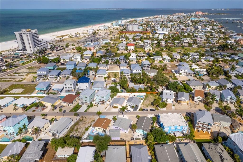 Coastal community with diverse architectural styles, featuring properties with visible proximity to both Gulf waters and a marina