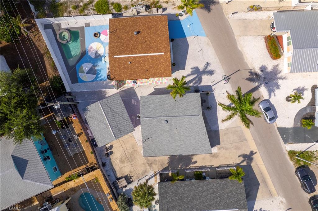 Aerial perspective showcasing a residential property with a brown shingle roof