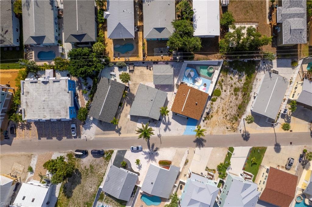 Aerial property overview featuring multiple residential structures and a street