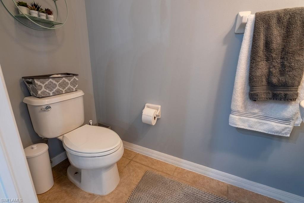 Bathroom with baseboards and tile patterned floors