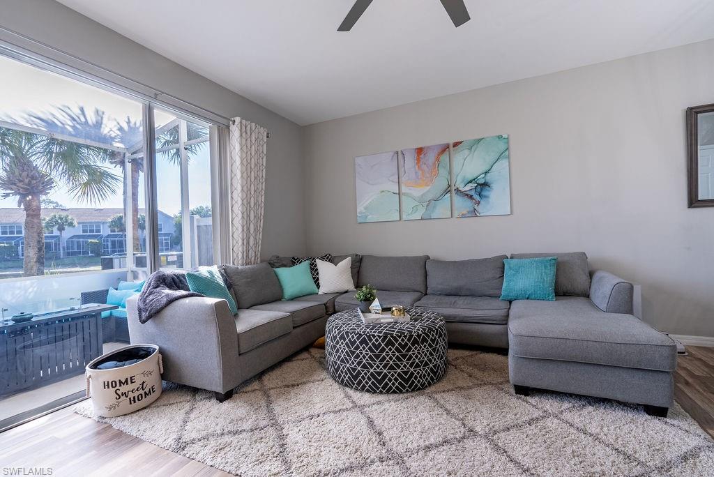 Living room with wood finished floors and a ceiling fan