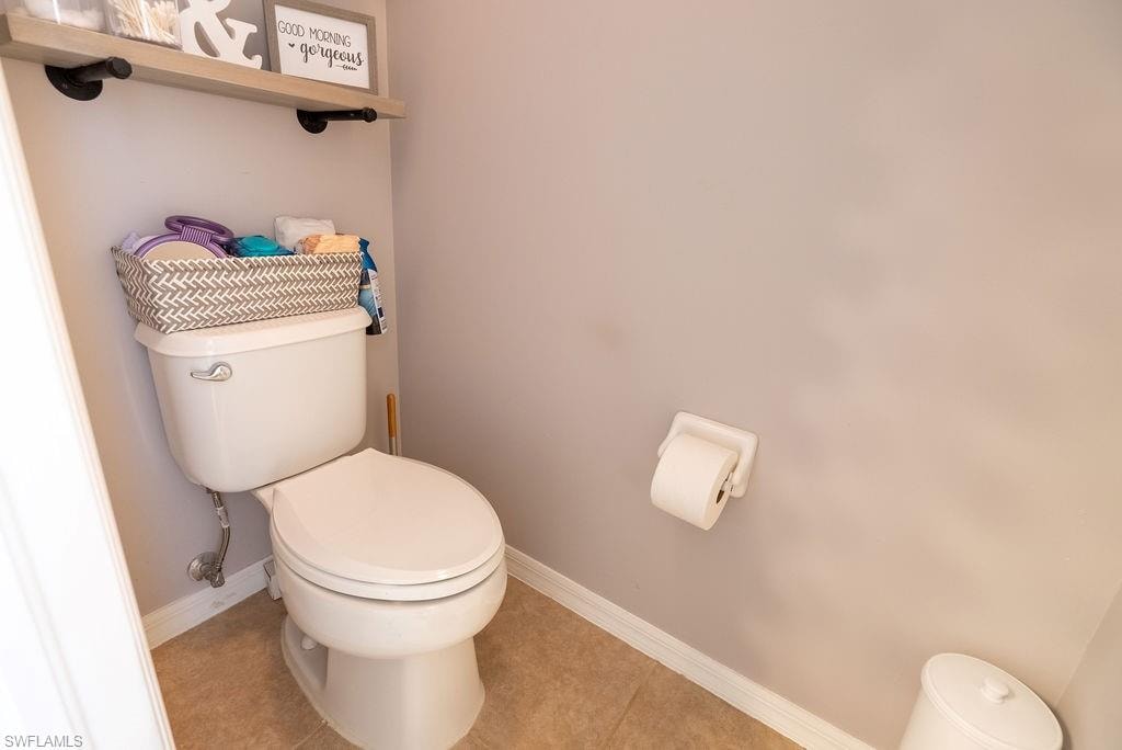 Bathroom featuring toilet and tile patterned flooring