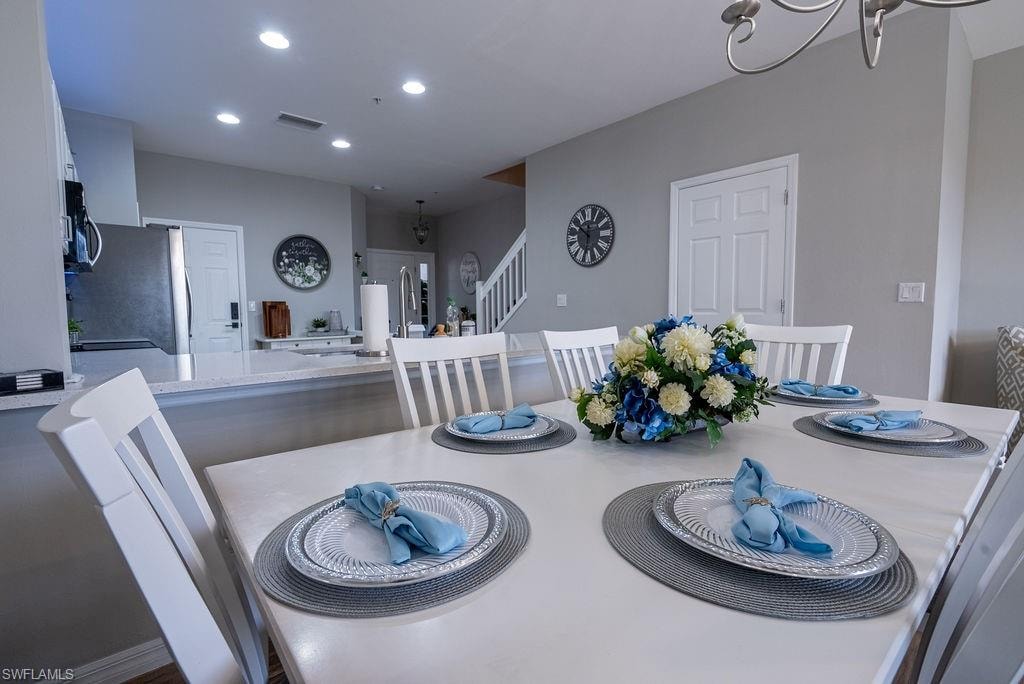 Dining room with recessed lighting and a chandelier