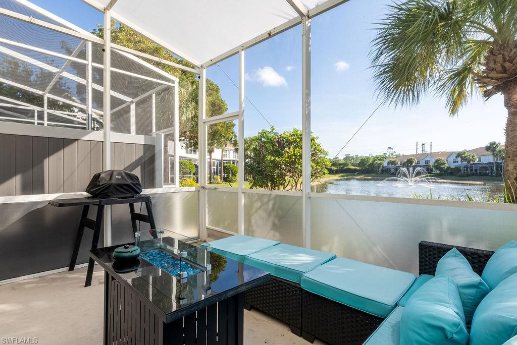 Sunroom featuring a water view