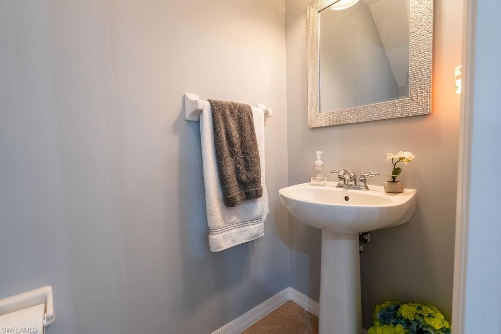 Bathroom featuring light tile patterned floors and baseboards