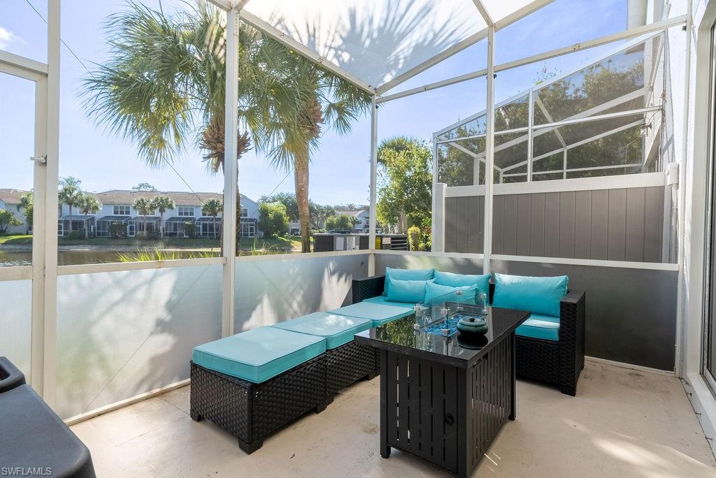 Sunroom with outdoor lounge area, plenty of natural light, a water view, and a patio