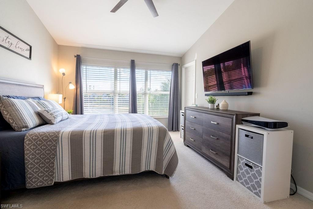 Bedroom with light colored carpet and ceiling fan