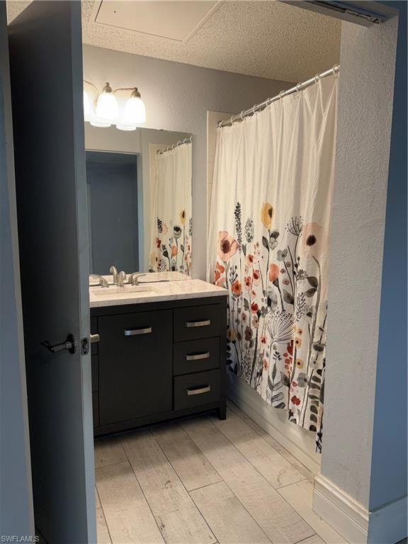 Bathroom featuring a dark wood vanity with a light-colored countertop, undermount sink, and chrome fixtures