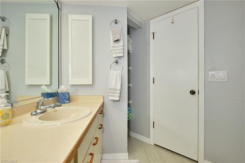 Bathroom featuring vanity and linen closet.