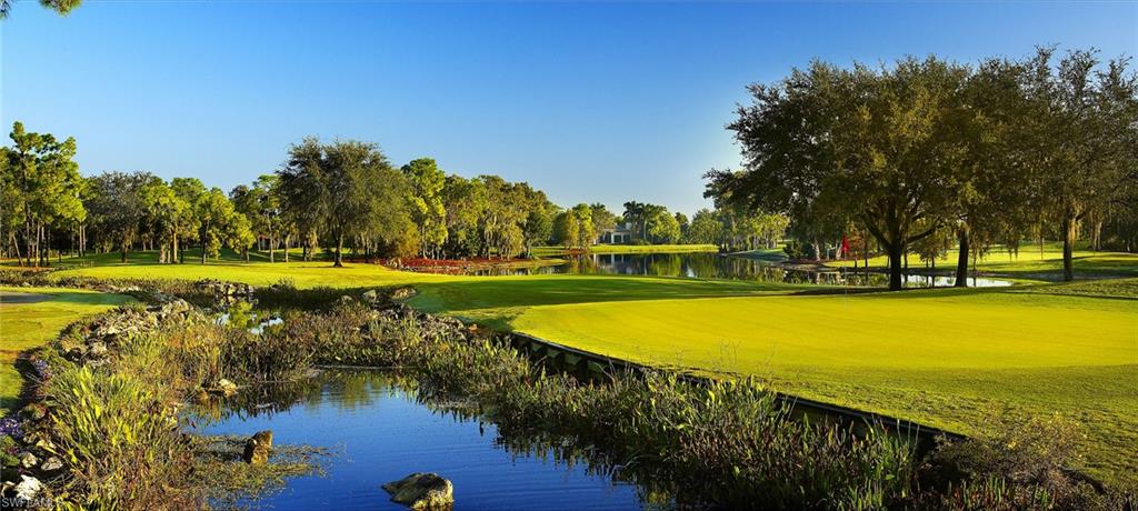 View of property's community featuring a water view, a yard, and golf course view