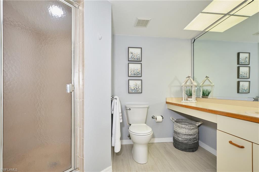 Owners bath with shower, vanity, and cabinet storage.