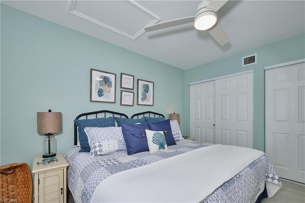 Very inviting guest bedroom with lighted ceiling fan, two closets, LTV flooring.
