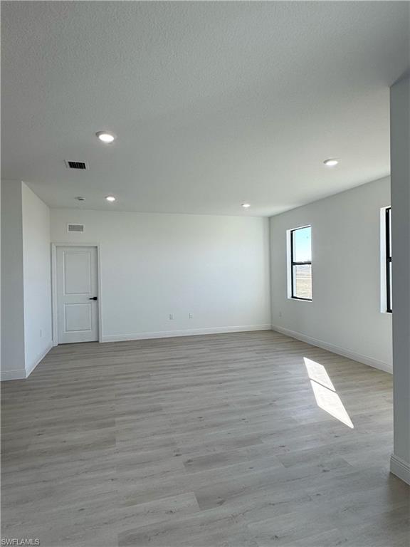 Spacious room with light wood-finish flooring