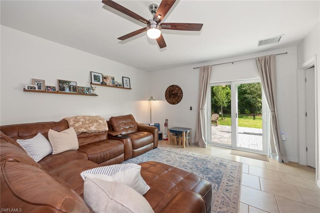 Light and bright living room features a double slider door