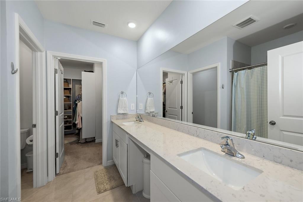 Primary bathroom features a double sink vanity