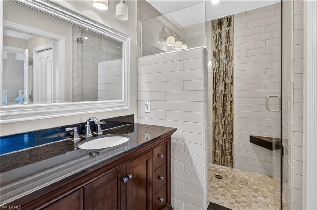 Vanity with a dark countertop and undermount sink
