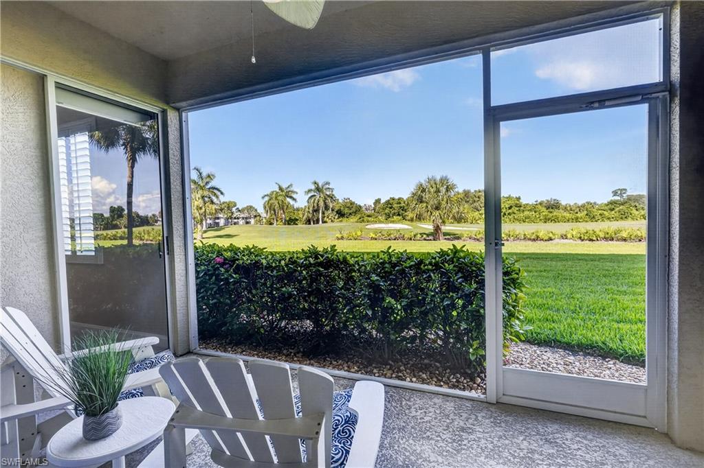 Screened lanai featuring textured concrete flooring and a ceiling fan