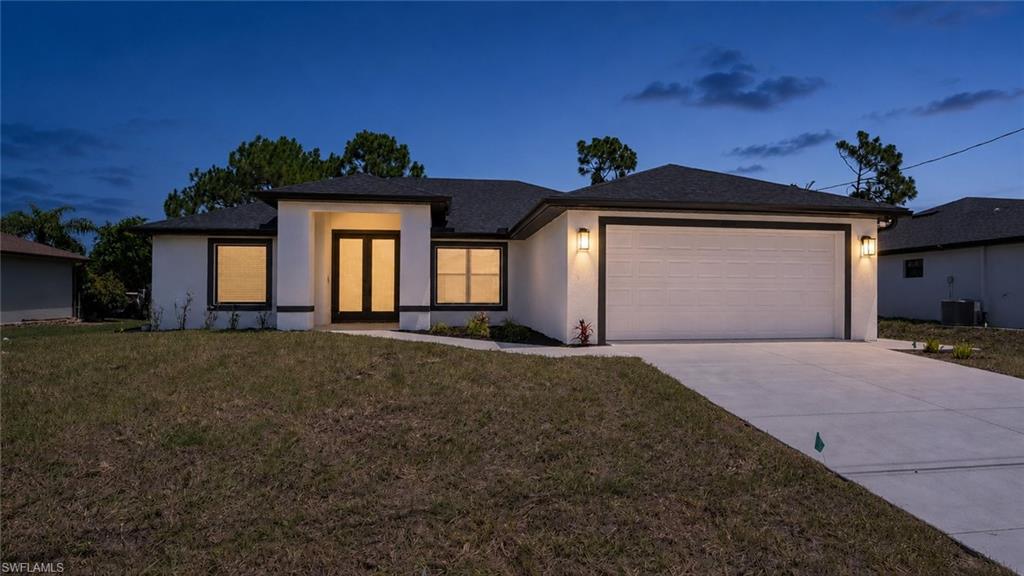 Contemporary stucco exterior with a dark shingle roof