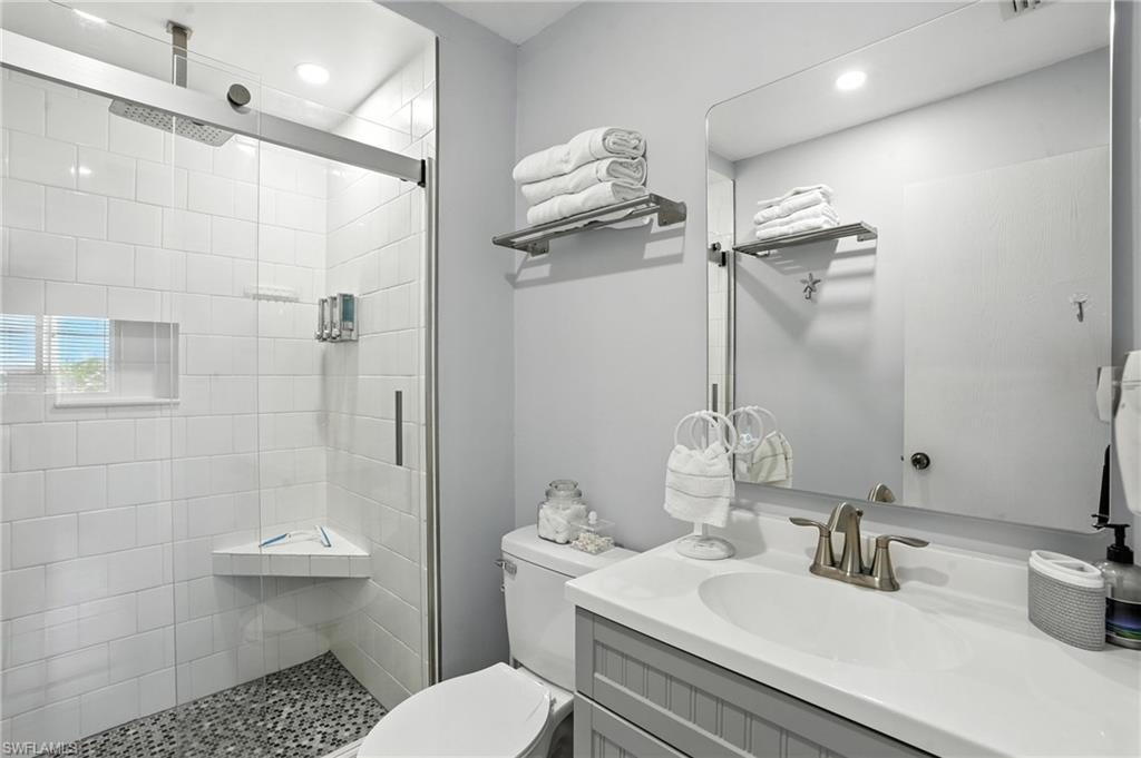 Bathroom featuring a walk-in shower with clear glass enclosure and a rain shower head