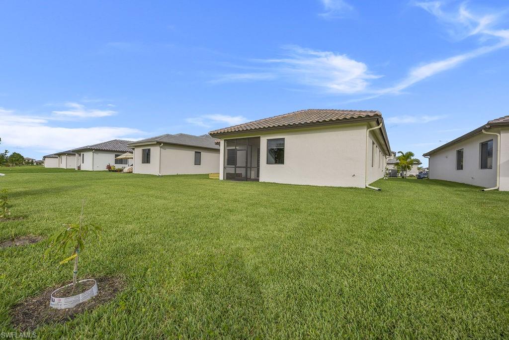 Rear view of house with a yard