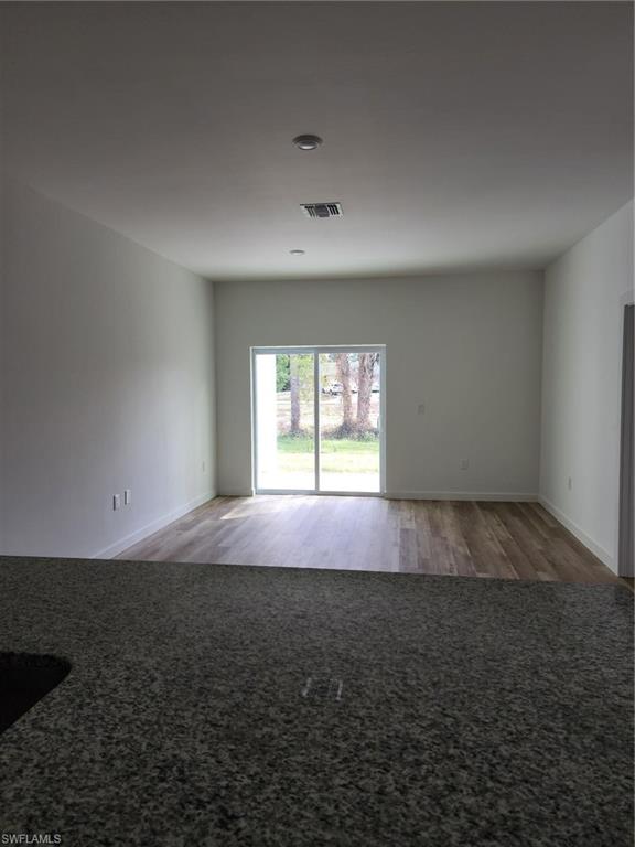 Unfurnished room featuring light wood-style flooring and baseboards