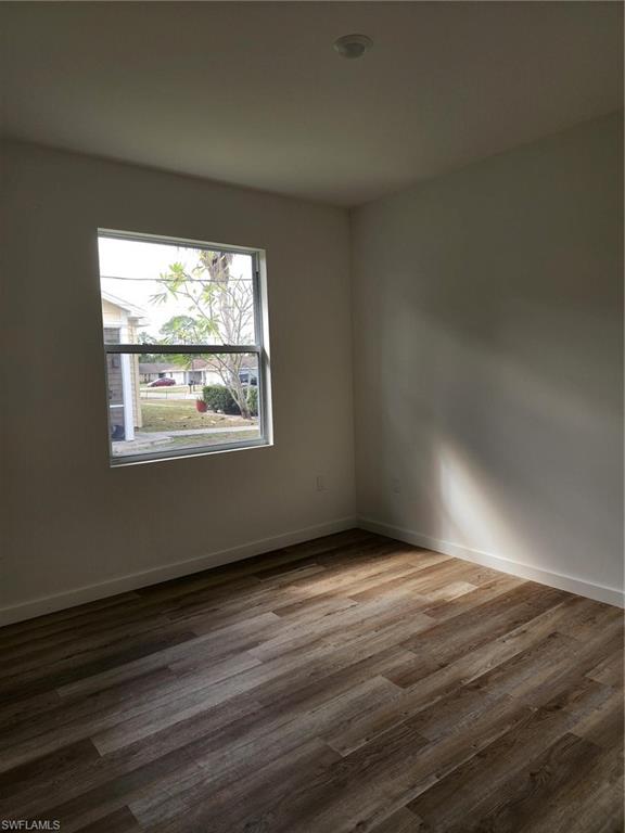 Empty room with wood finished floors and baseboards