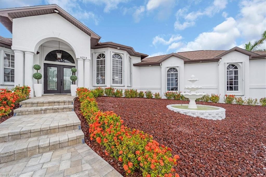 Entrance to property with stucco siding and french doors
