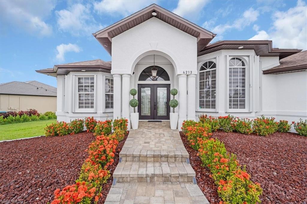 Entrance to property with french doors and stucco siding