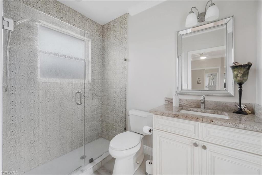 Full bath with a stall shower and vanity