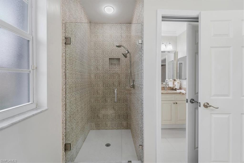 Bathroom with a stall shower, vanity, and light tile patterned floors
