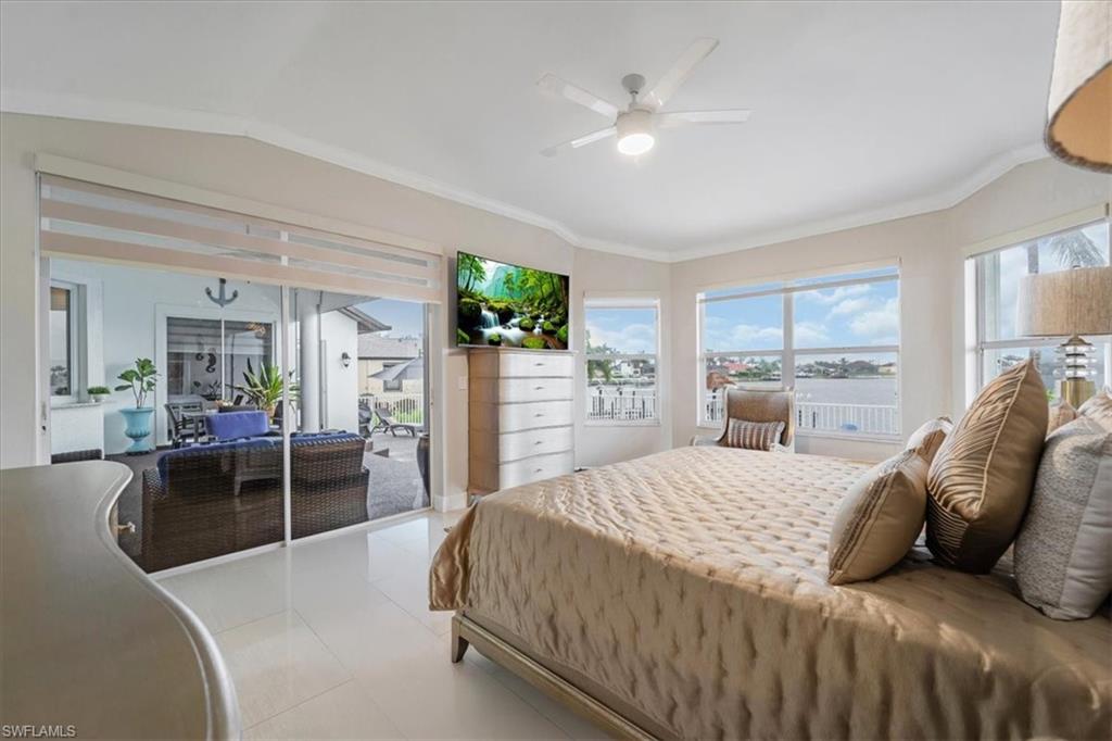 Bedroom featuring access to outside, tile patterned floors, a ceiling fan, and crown molding