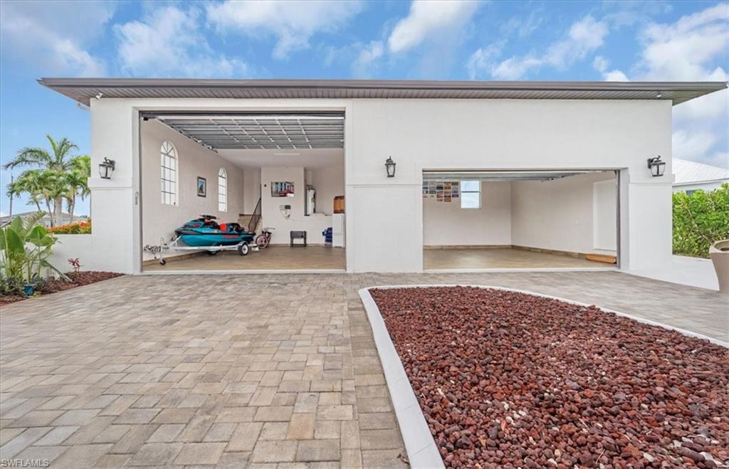Garage featuring decorative driveway