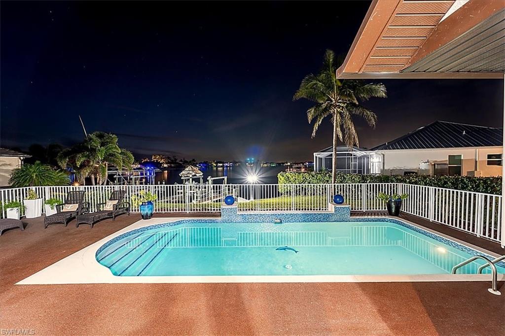 Pool at night with a patio