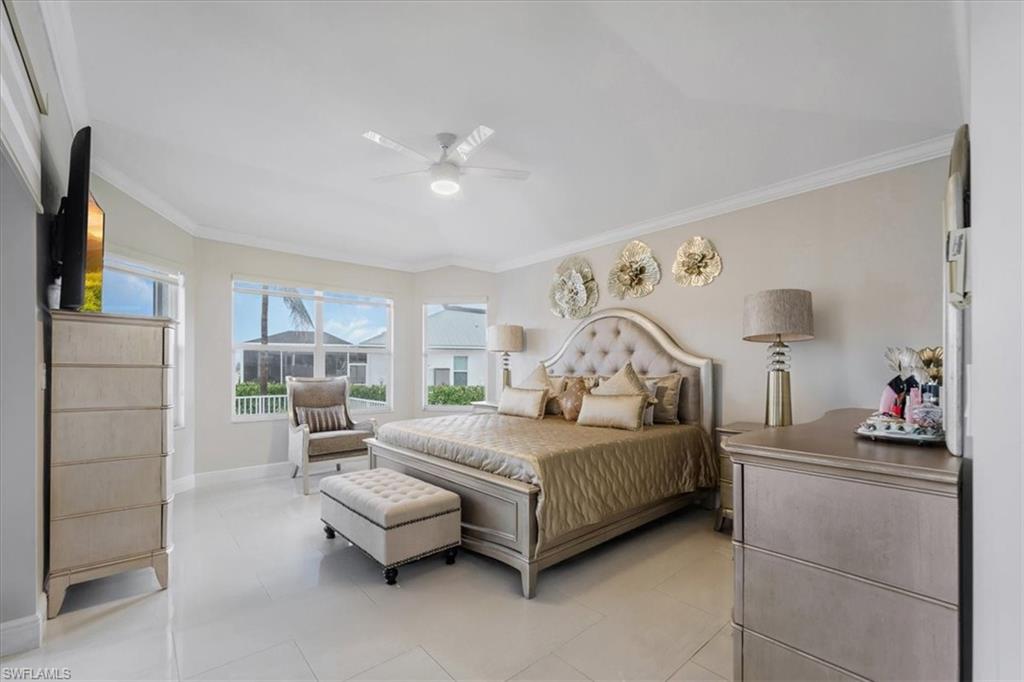 Bedroom featuring crown molding, a ceiling fan, and light tile patterned floors