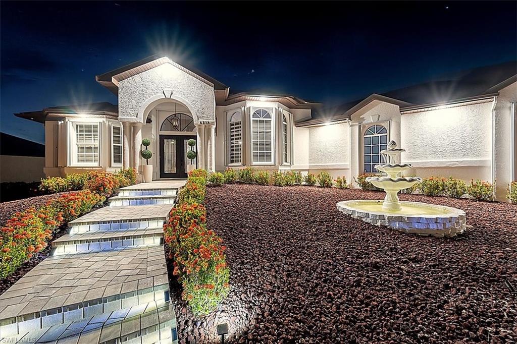 View of front of home with french doors and stucco siding