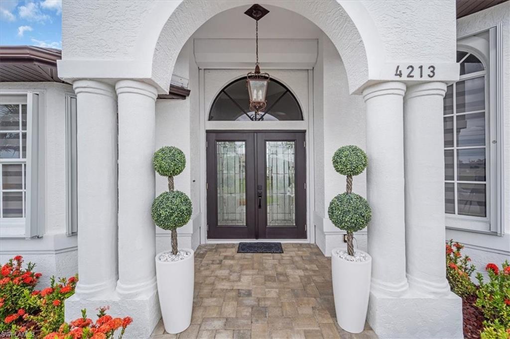 Doorway to property with stucco siding and french doors