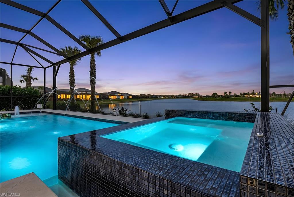 Integrated pool / hot tub featuring a patio, glass enclosure, a water view, and a sunroom