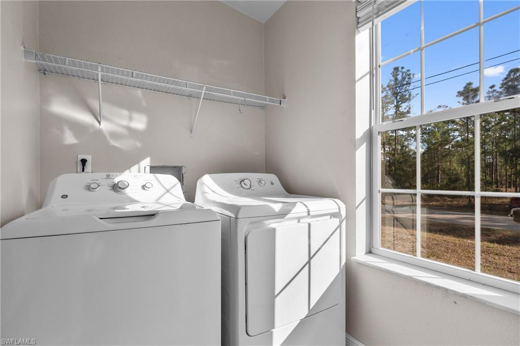 Washroom featuring washing machine and dryer